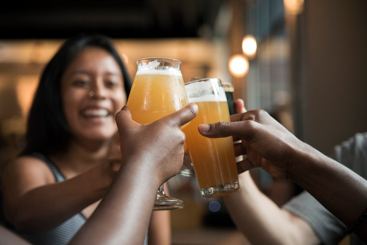 People giving cheers over beers.