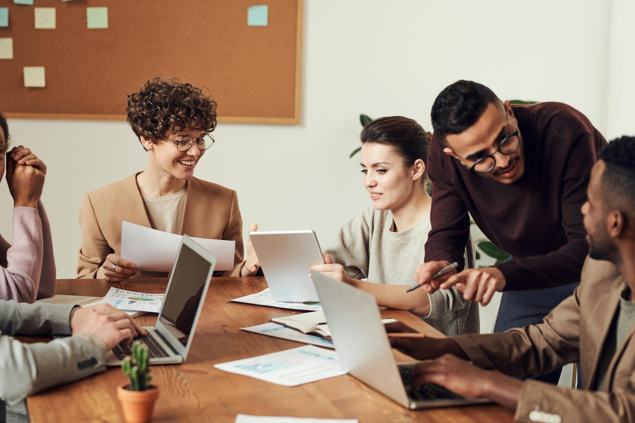 Diversity in the workplace. Men and women of differing ethnicity at a conference table.