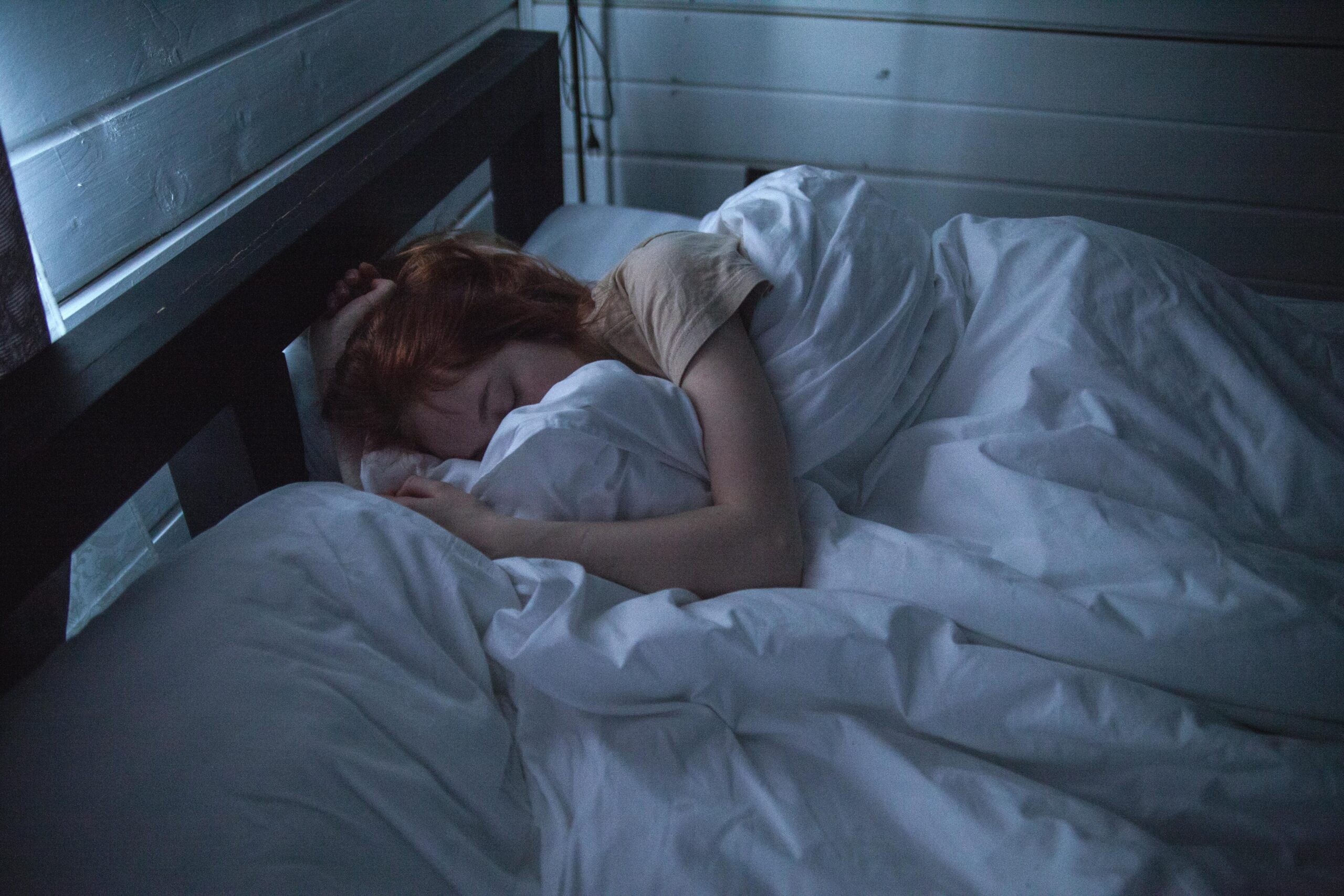 Woman sleeping in bed.